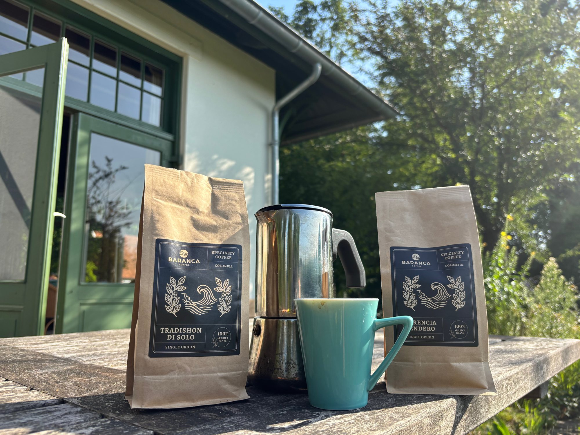 Two Baranca coffees with a moka pot and cup outdoors
